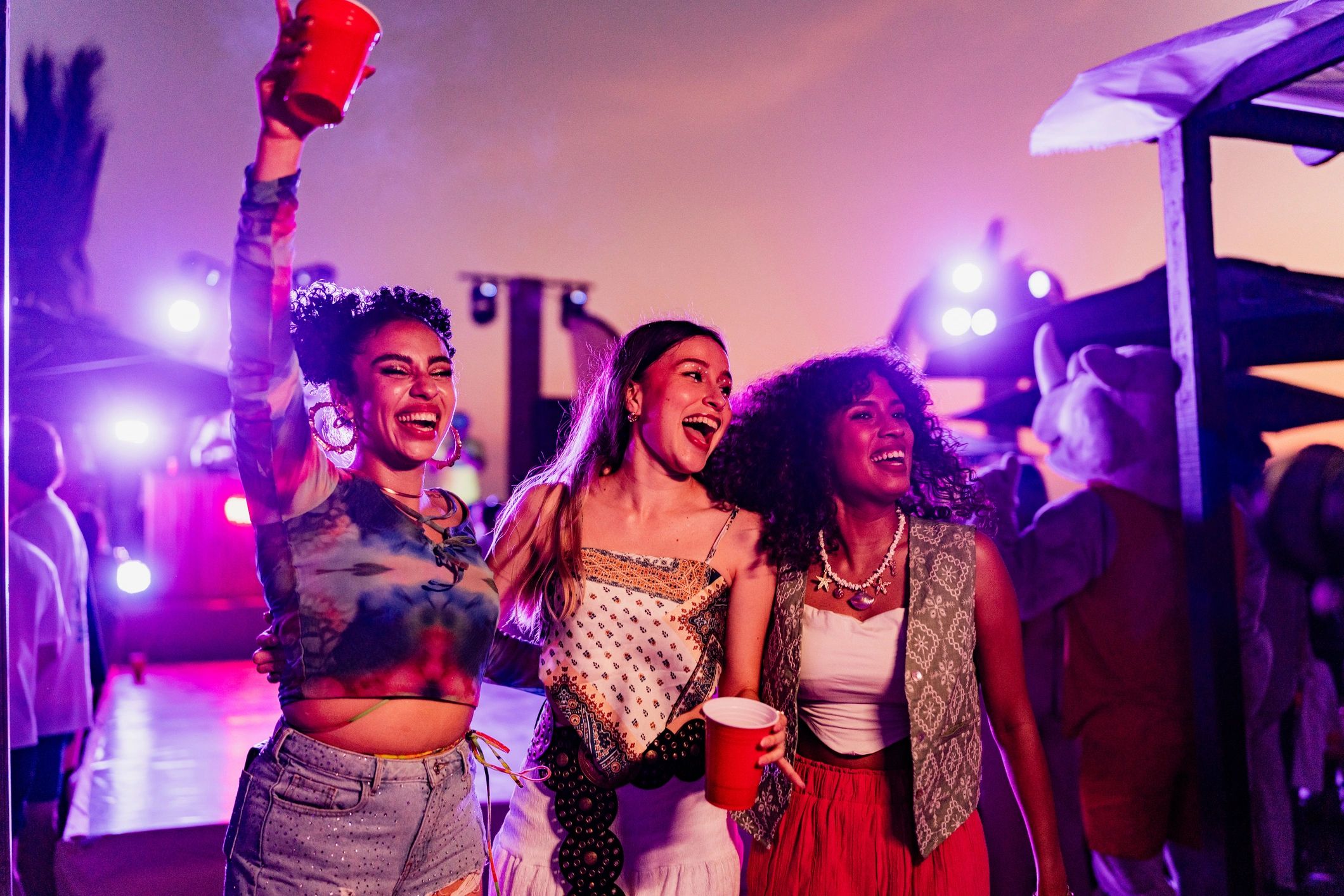 Friends dancing outdoors at a lively party